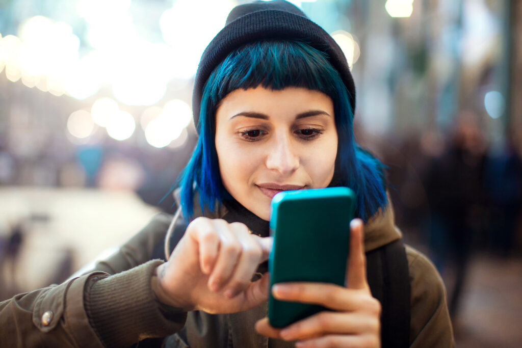 Person in hat using phone