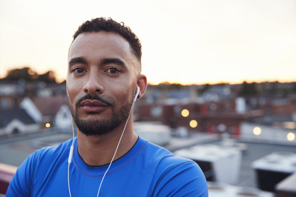 Man with earphones in front of skyline